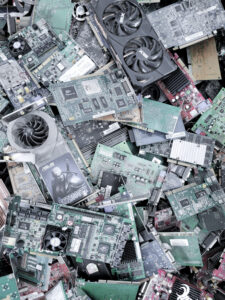 Numerous motherboards and other computer parts piling up in a landfill